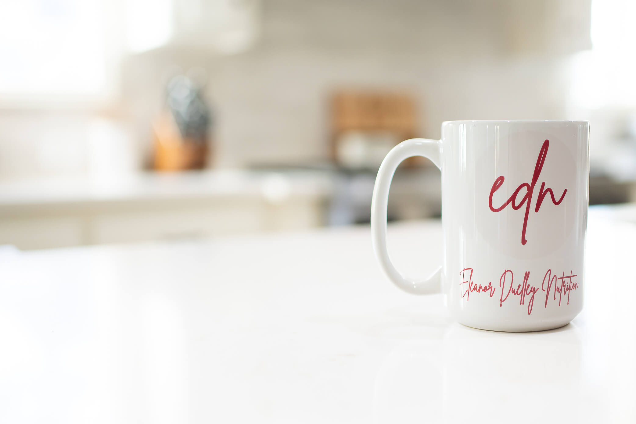 branded coffee mug on white counter 