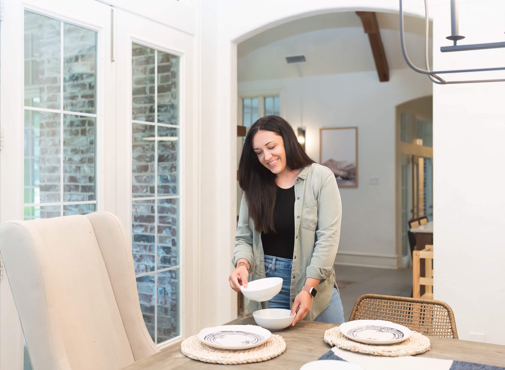 woman staging a dining table for an interior design team brnading session