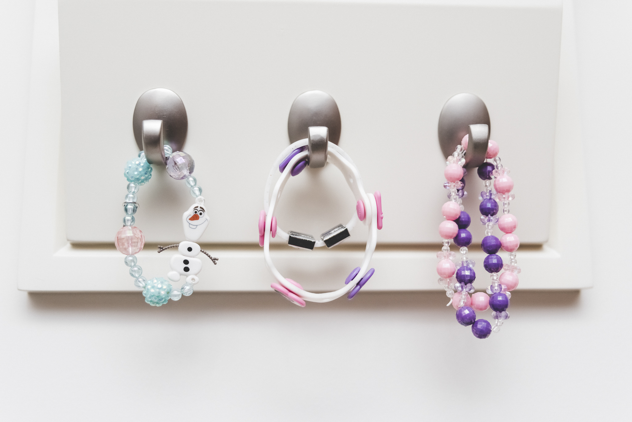 little girl jewelry hanging on hooks