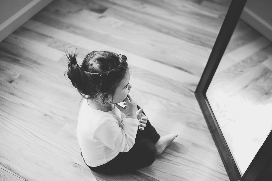 small girl looking at herself in the mirror, shot in black and white