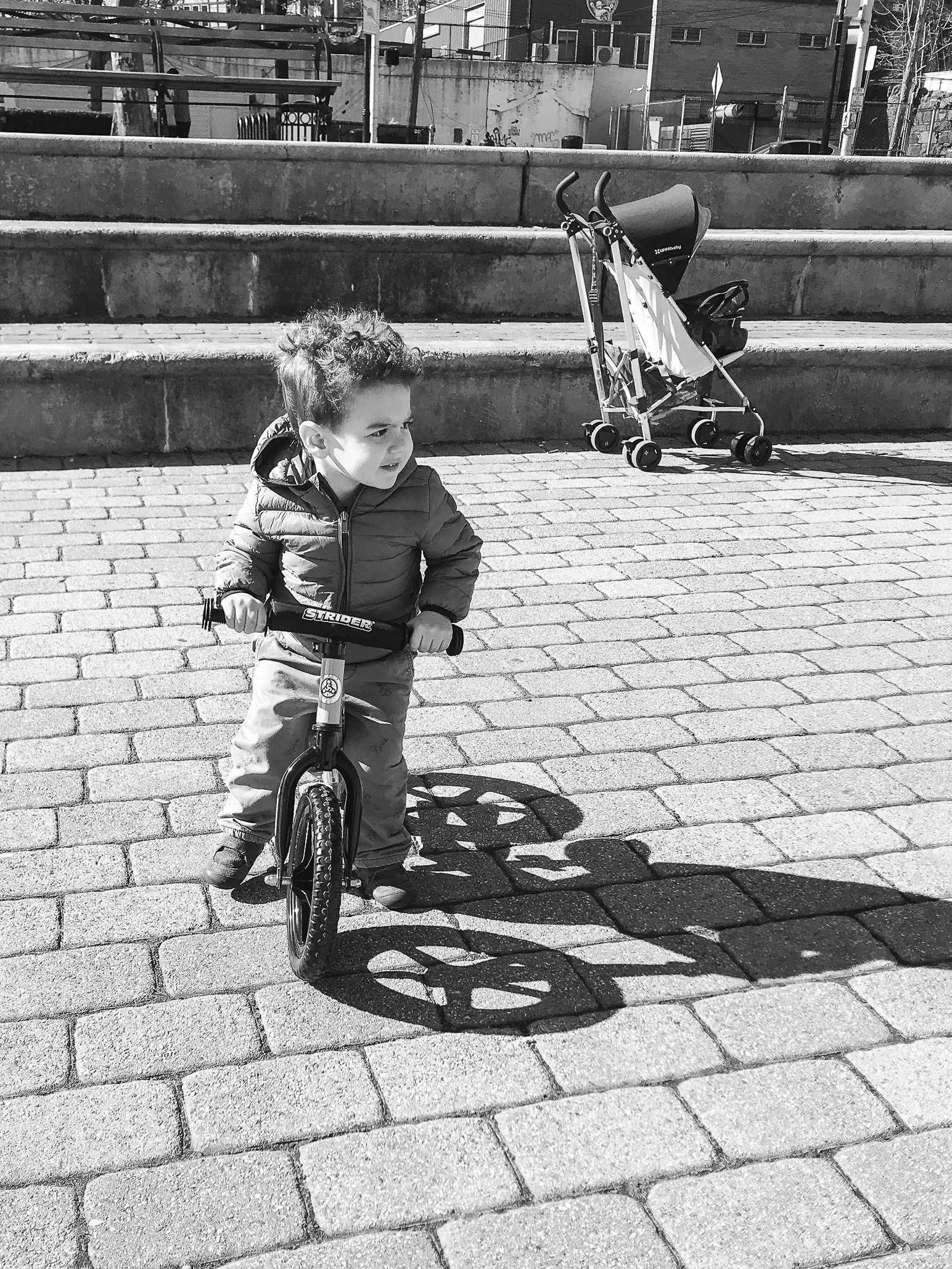 Black & white photo of a preschooler on a bike