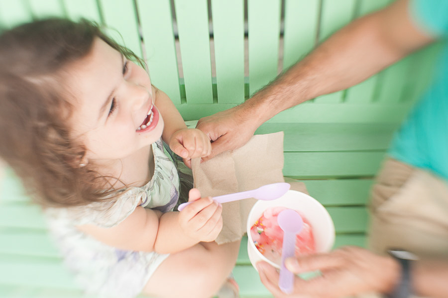 Little girl and dad laughing having ice cream