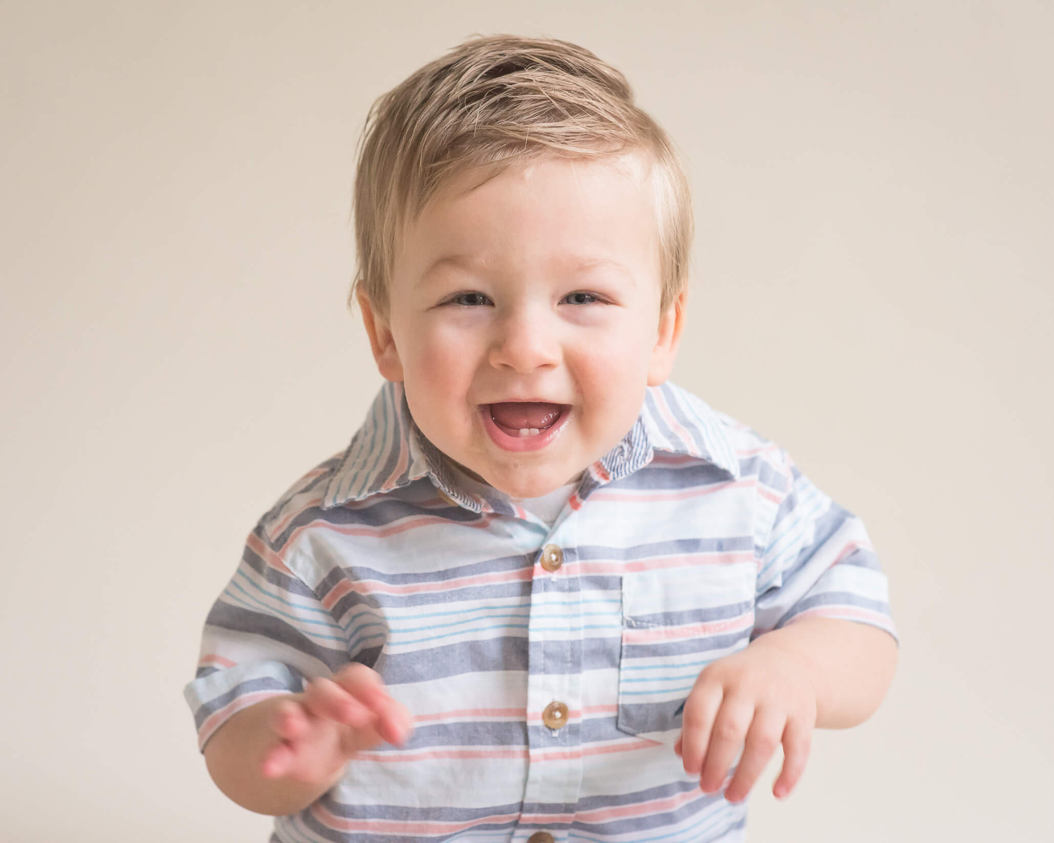 adorable toddler in studio portrait wearing striped shirt
