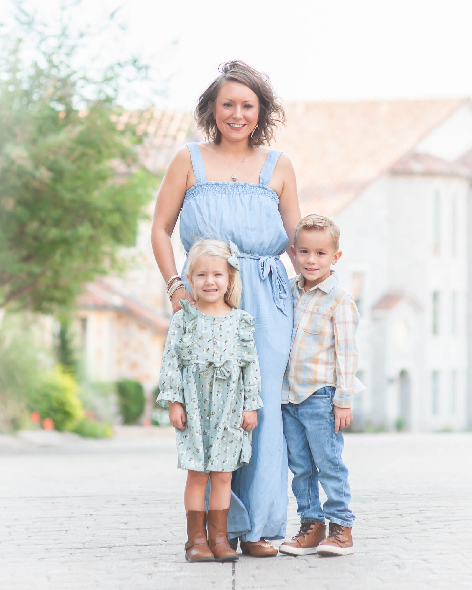 Beautiful mom and 2 small kiddos all well dressed