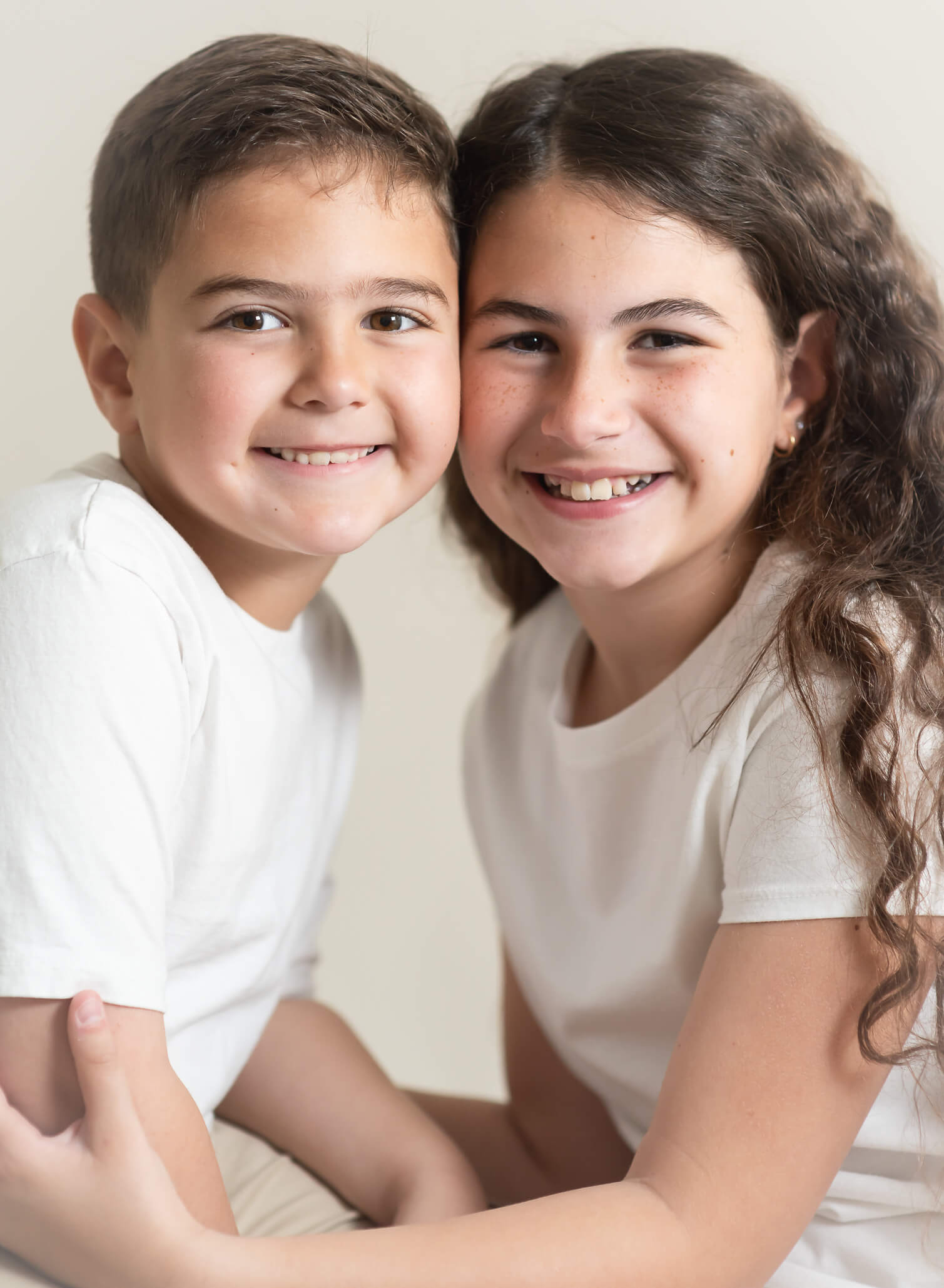 siblings smiling in sibling photo session