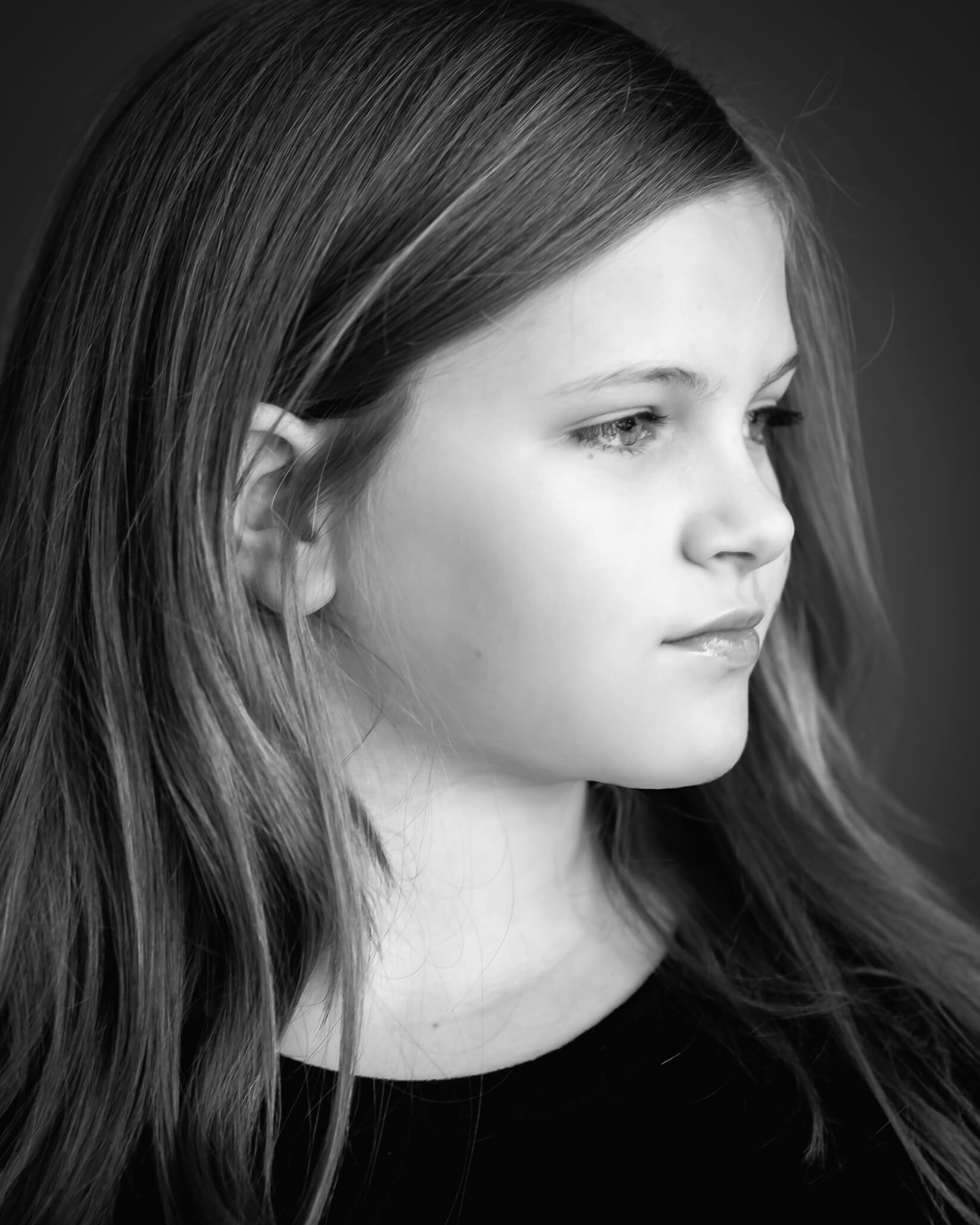 stunning black and white studio portrait of 10 year old girl's profile