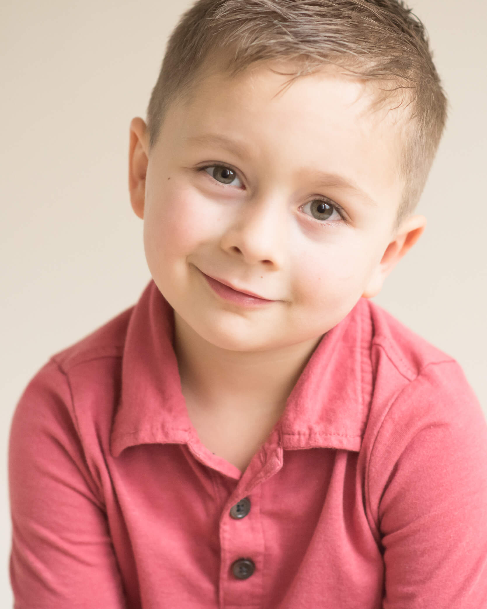 adorable little boy in red shirt studio portrait