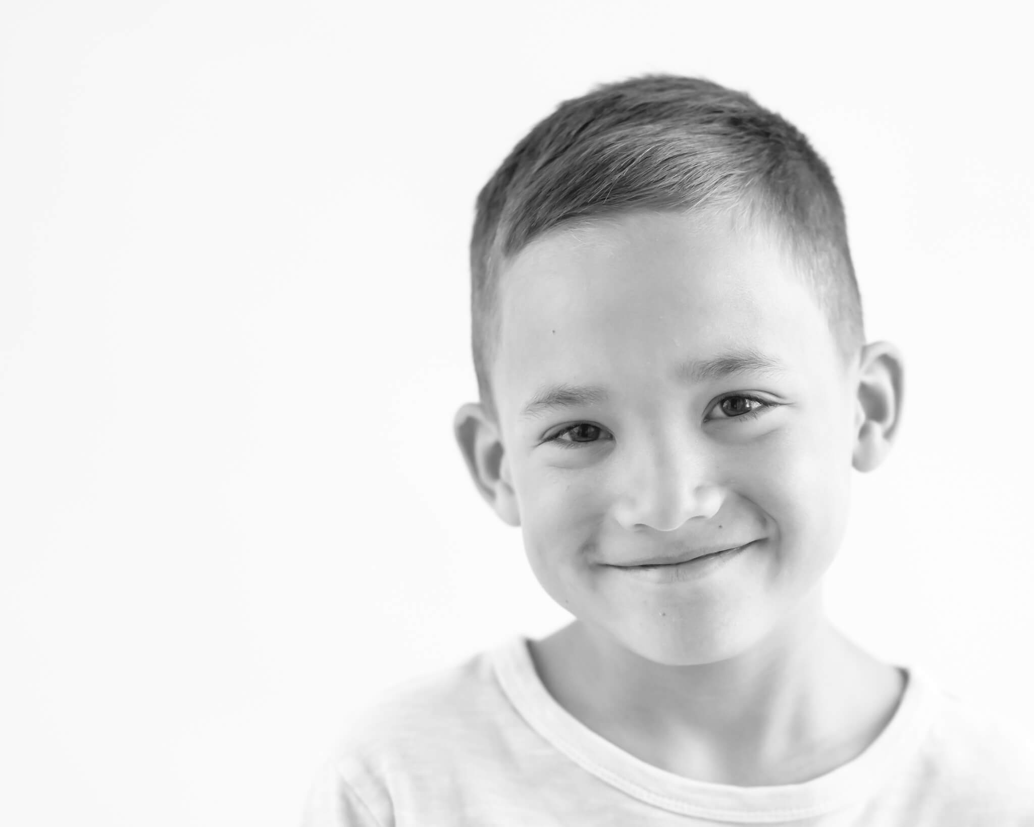 8 year old boy black and white studio portrait captured by Allison Amores Photography
