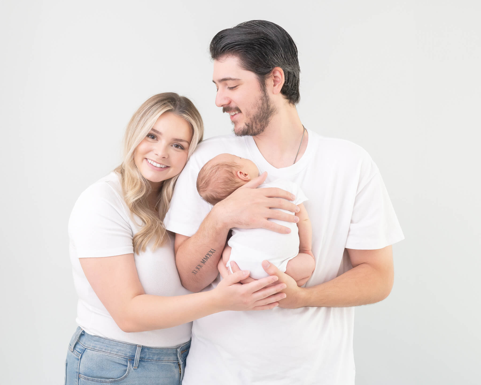 parents with newborn in studio for timeless portraits captured by Allison Amores Photography